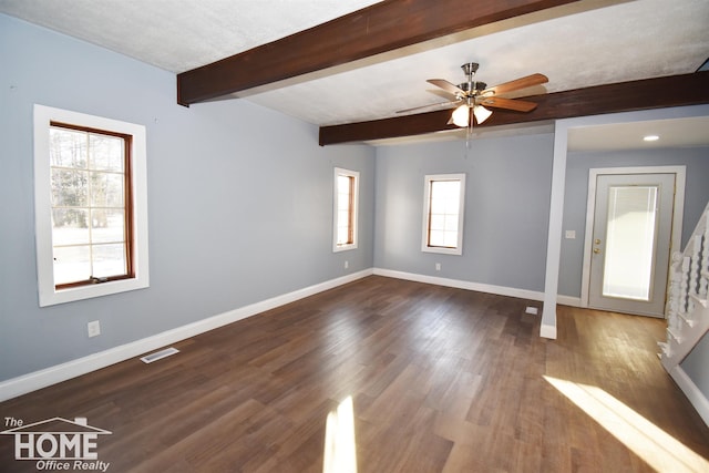 empty room featuring dark hardwood / wood-style flooring, ceiling fan, and beam ceiling