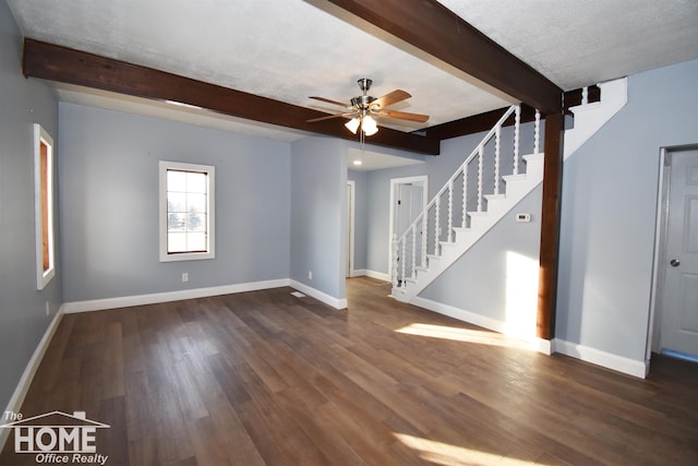 unfurnished living room with ceiling fan, beam ceiling, dark hardwood / wood-style flooring, and a textured ceiling