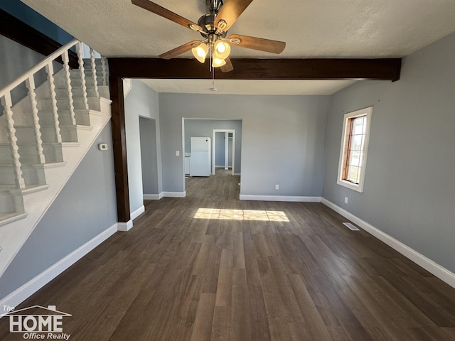 unfurnished living room with beamed ceiling, ceiling fan, dark hardwood / wood-style floors, and a textured ceiling