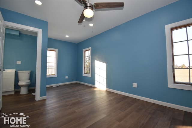 unfurnished bedroom with ceiling fan and dark hardwood / wood-style flooring