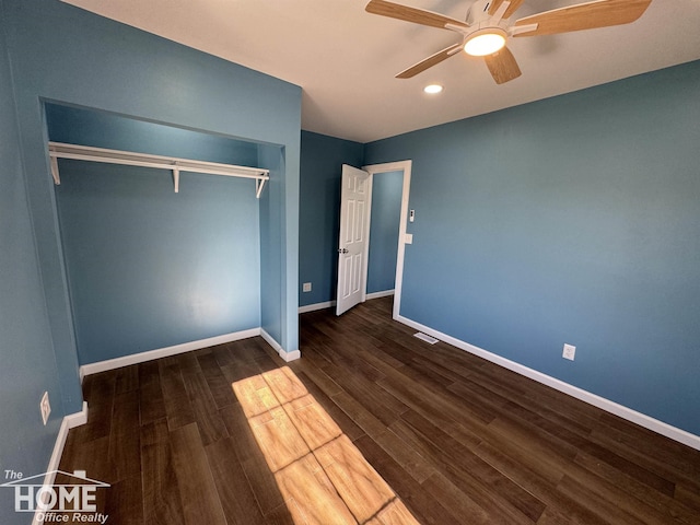 unfurnished bedroom with dark wood-type flooring, a closet, and ceiling fan