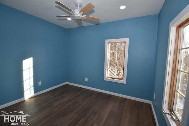 empty room with dark hardwood / wood-style flooring and ceiling fan