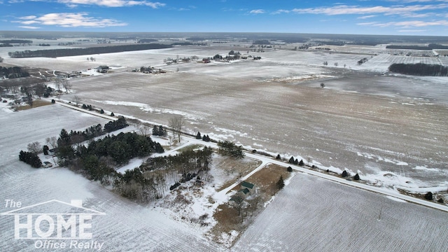 snowy aerial view featuring a rural view