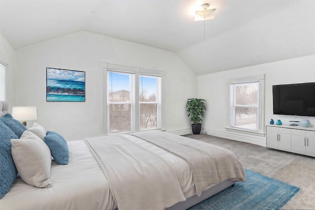 bedroom with a baseboard radiator, lofted ceiling, and light carpet