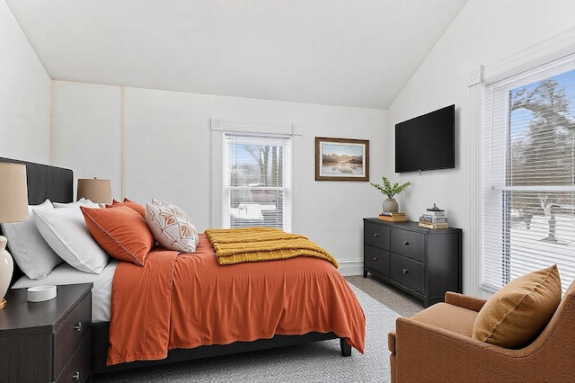 bedroom with light carpet and vaulted ceiling
