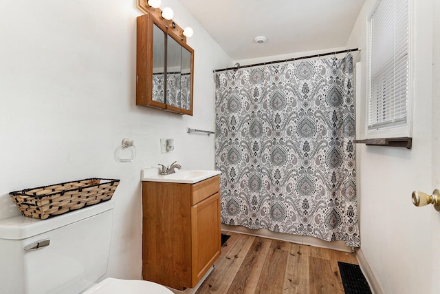bathroom featuring vanity, toilet, a shower with shower curtain, and wood-type flooring