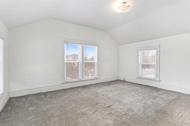 bonus room featuring lofted ceiling, a wealth of natural light, and carpet