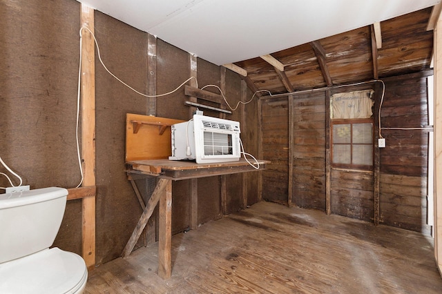interior space with hardwood / wood-style floors and toilet