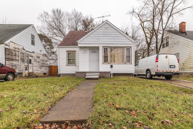 bungalow-style home featuring a front yard