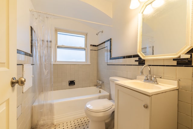 full bathroom featuring tile walls, vanity, toilet, and shower / tub combo with curtain