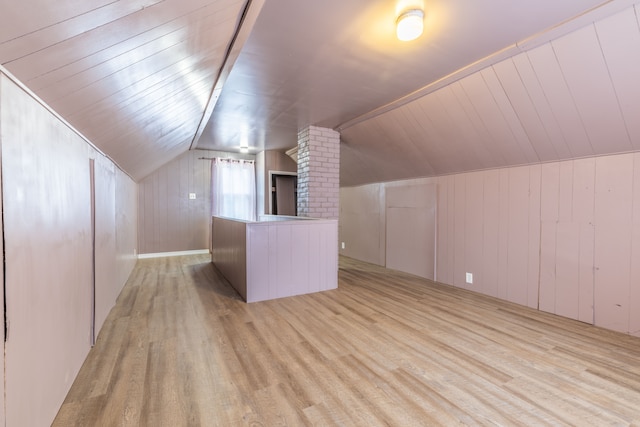 additional living space with vaulted ceiling, wooden walls, light hardwood / wood-style floors, and wooden ceiling