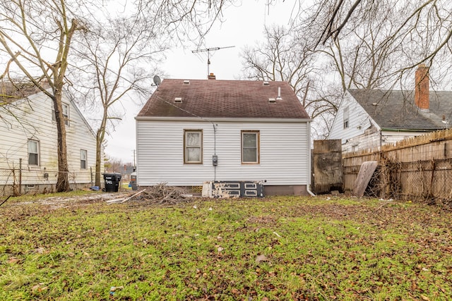 back of house with a lawn