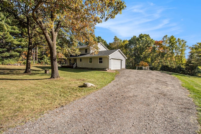 view of front of house with a front yard and a garage