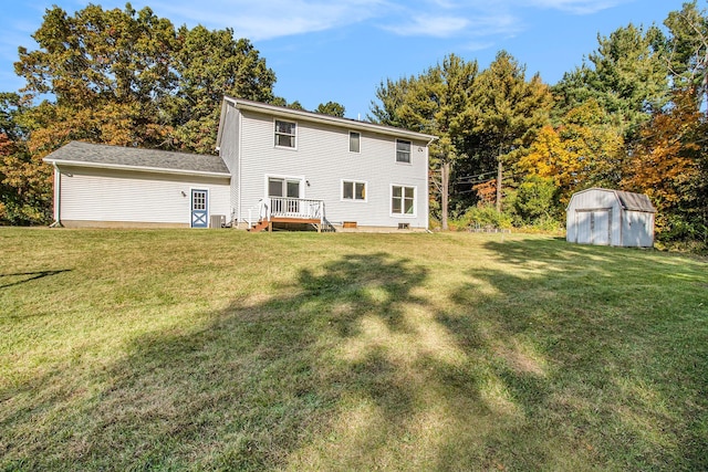 back of house featuring a yard and a storage unit