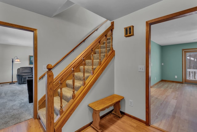 staircase with hardwood / wood-style floors