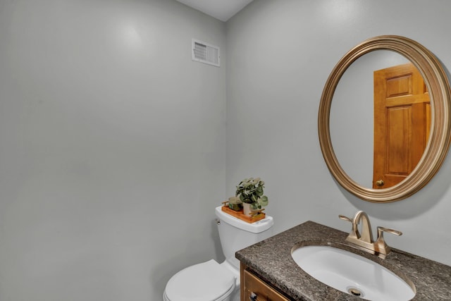 bathroom featuring toilet and vanity