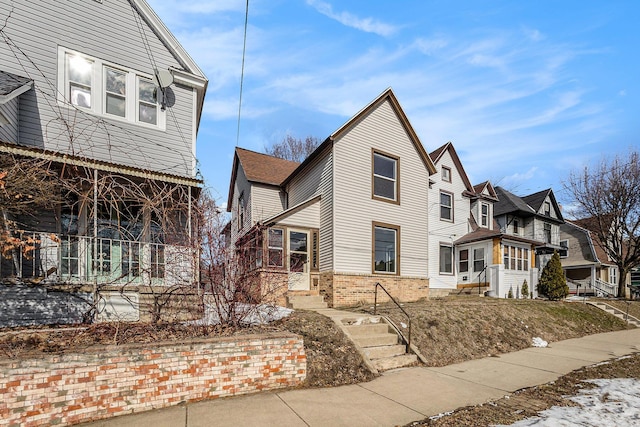 view of front of home featuring a residential view and brick siding