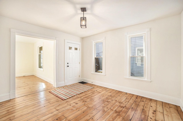 entryway with light wood-style floors and baseboards