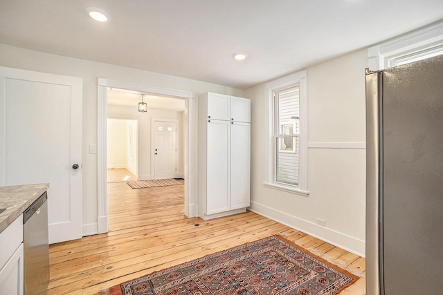 interior space featuring light wood finished floors, baseboards, and recessed lighting