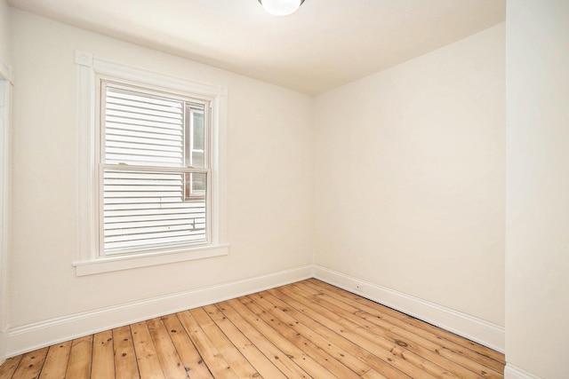 unfurnished room with a wealth of natural light, light wood-style flooring, and baseboards