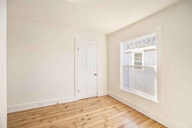 unfurnished room featuring light wood-style flooring and baseboards