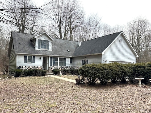 cape cod-style house with a shingled roof