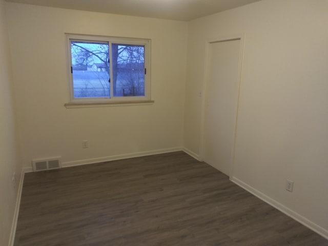 empty room featuring dark hardwood / wood-style floors