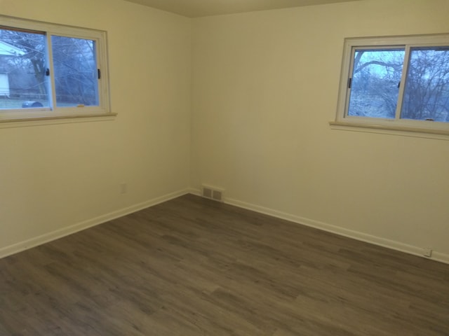 spare room with dark hardwood / wood-style floors