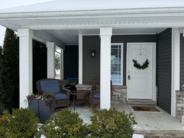 view of exterior entry with covered porch