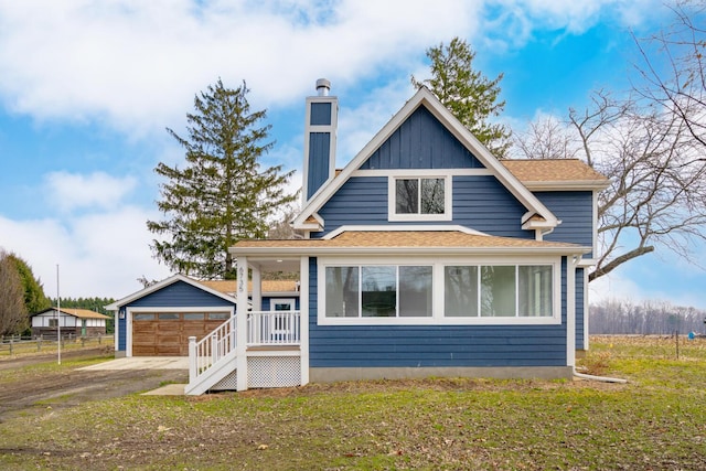 6735 S Scottdale Rd, Berrien Springs, MI 49103 - view of front of property with a detached garage, a chimney, fence, an outdoor structure, and board and batten siding