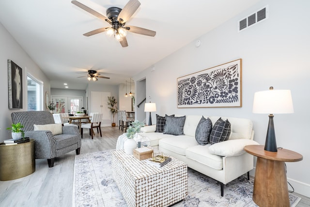 6735 S Scottdale Rd, Berrien Springs, MI 49103 - living area featuring light wood-style floors, visible vents, ceiling fan, and baseboards