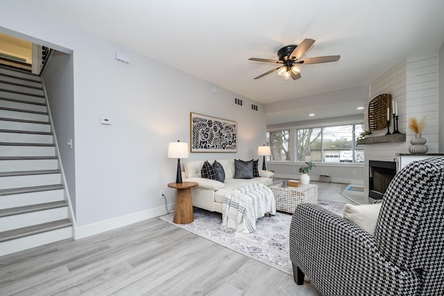6735 S Scottdale Rd, Berrien Springs, MI 49103 - living area featuring baseboards, a ceiling fan, stairway, wood finished floors, and a fireplace