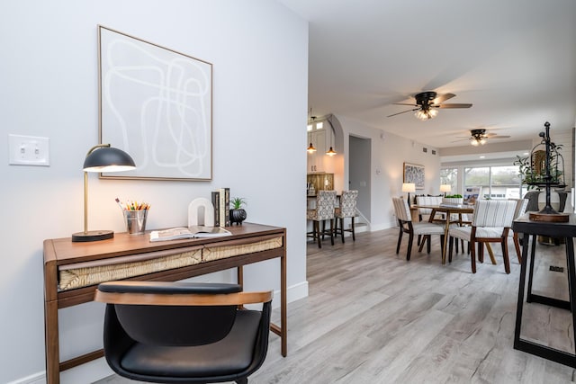 6735 S Scottdale Rd, Berrien Springs, MI 49103 - dining area with light wood-style flooring and baseboards