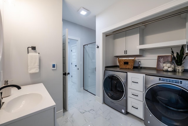 6735 S Scottdale Rd, Berrien Springs, MI 49103 - laundry area featuring marble finish floor, washing machine and dryer, a sink, and baseboards