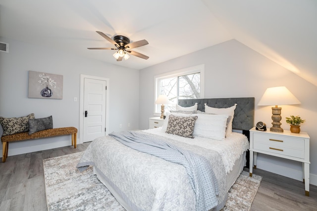 6735 S Scottdale Rd, Berrien Springs, MI 49103 - bedroom with baseboards, visible vents, a ceiling fan, wood finished floors, and vaulted ceiling