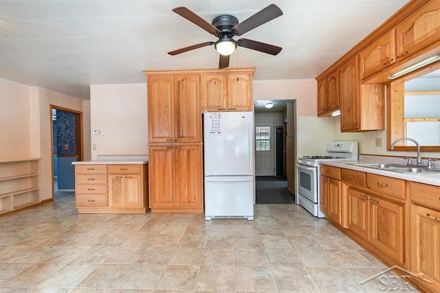 kitchen featuring ceiling fan, white appliances, and sink