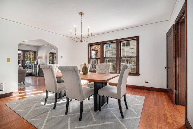 dining area featuring a notable chandelier and hardwood / wood-style flooring