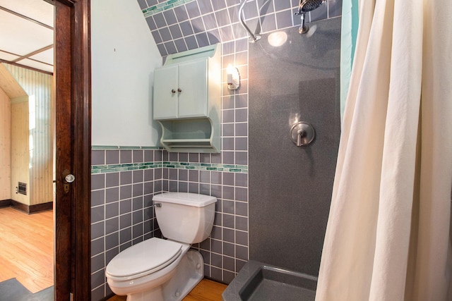 bathroom with hardwood / wood-style floors, tile walls, curtained shower, and toilet