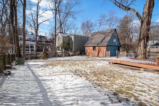 yard covered in snow with a deck