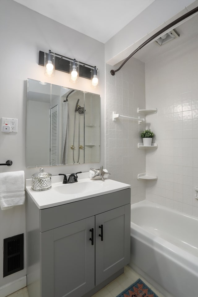 bathroom with vanity and tiled shower / bath combo