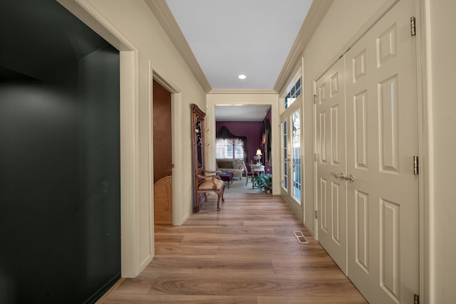 hallway featuring french doors, recessed lighting, visible vents, light wood-style flooring, and ornamental molding