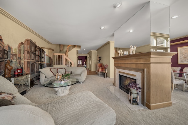 living area featuring a premium fireplace, ornamental molding, carpet, stairs, and recessed lighting