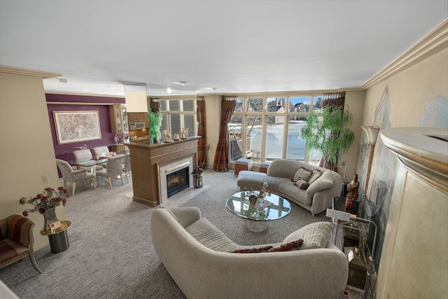 living room with a fireplace with flush hearth, carpet flooring, and ornamental molding