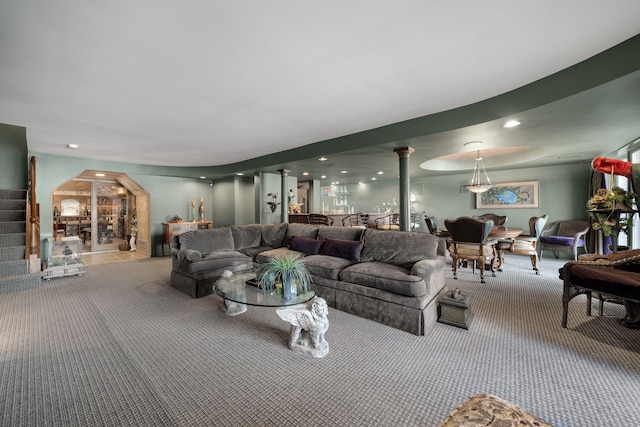 living area featuring arched walkways, recessed lighting, carpet flooring, ornate columns, and stairs