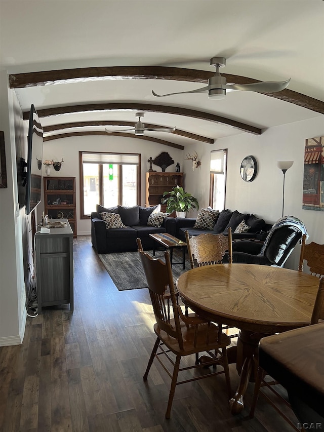 dining area with ceiling fan, dark hardwood / wood-style floors, and vaulted ceiling with beams