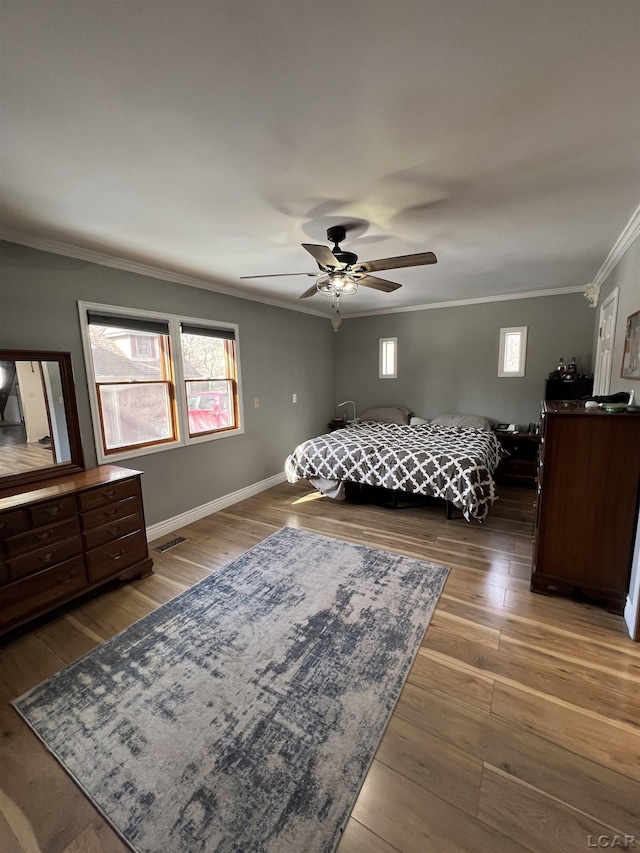 bedroom featuring dark hardwood / wood-style flooring, ornamental molding, and ceiling fan