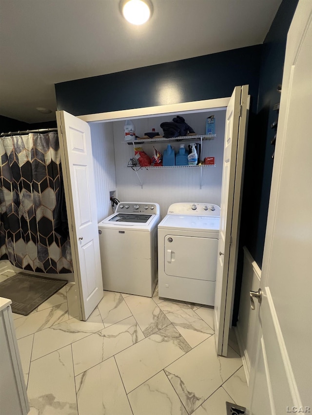 clothes washing area with washing machine and dryer