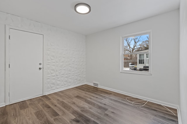 spare room featuring hardwood / wood-style flooring