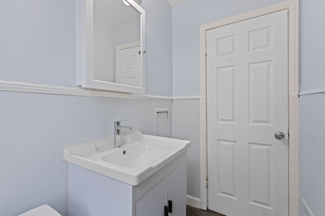 bathroom with tile walls and vanity