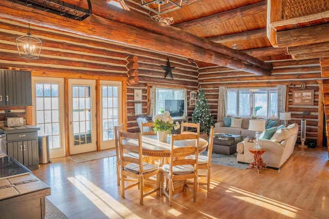 dining space featuring beamed ceiling, wood ceiling, and light hardwood / wood-style floors